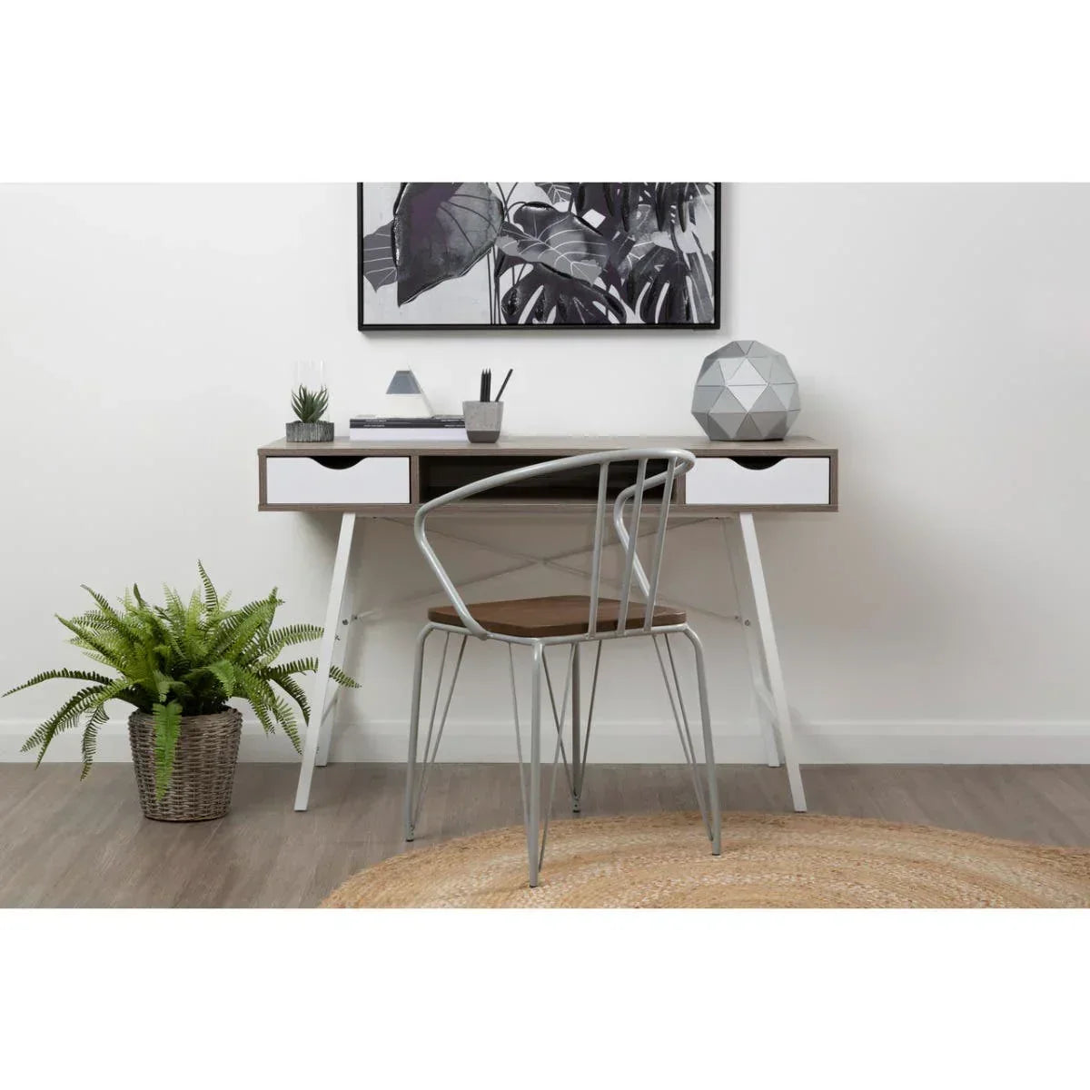 Home office desk with two drawers and metal chair, modern decor, plant on the floor