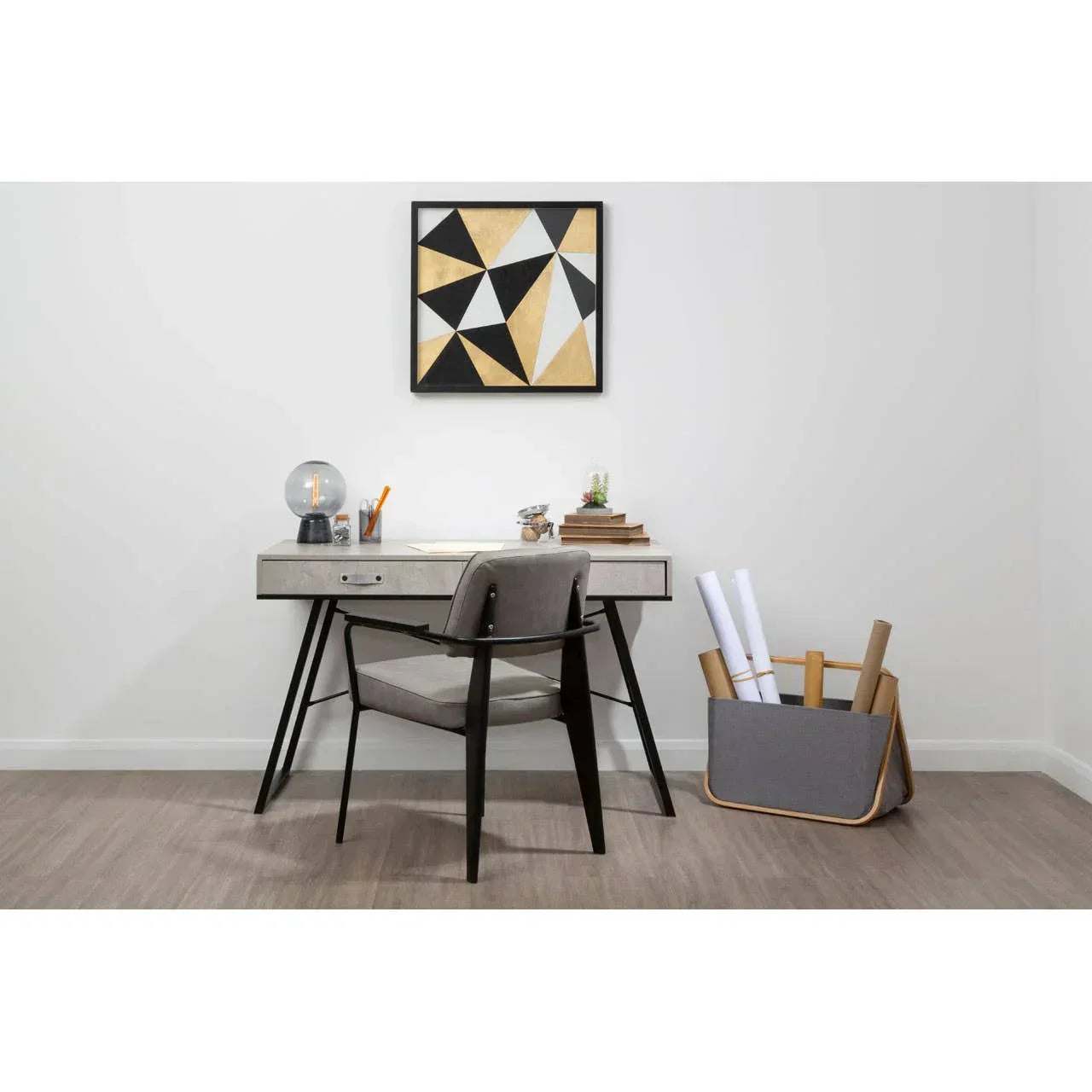Modern home office desk with grey chair and storage basket on wood floor