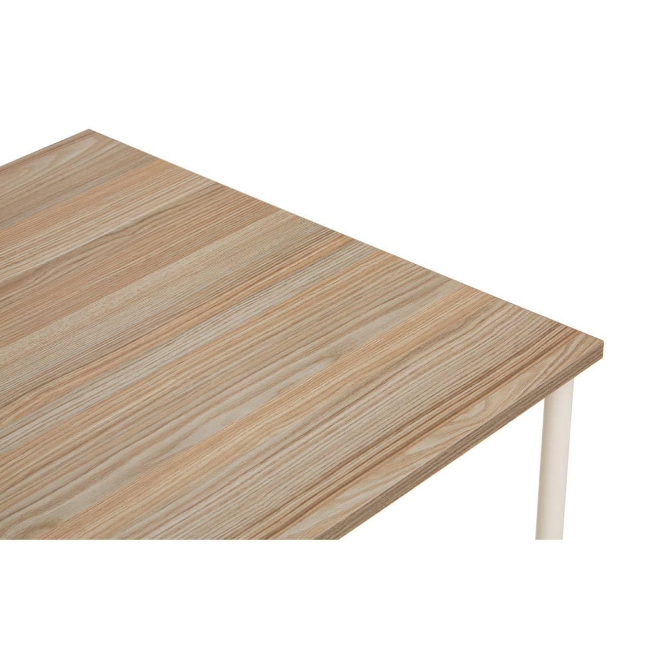 Light wood dining table with natural grain detail and white metal leg, corner view