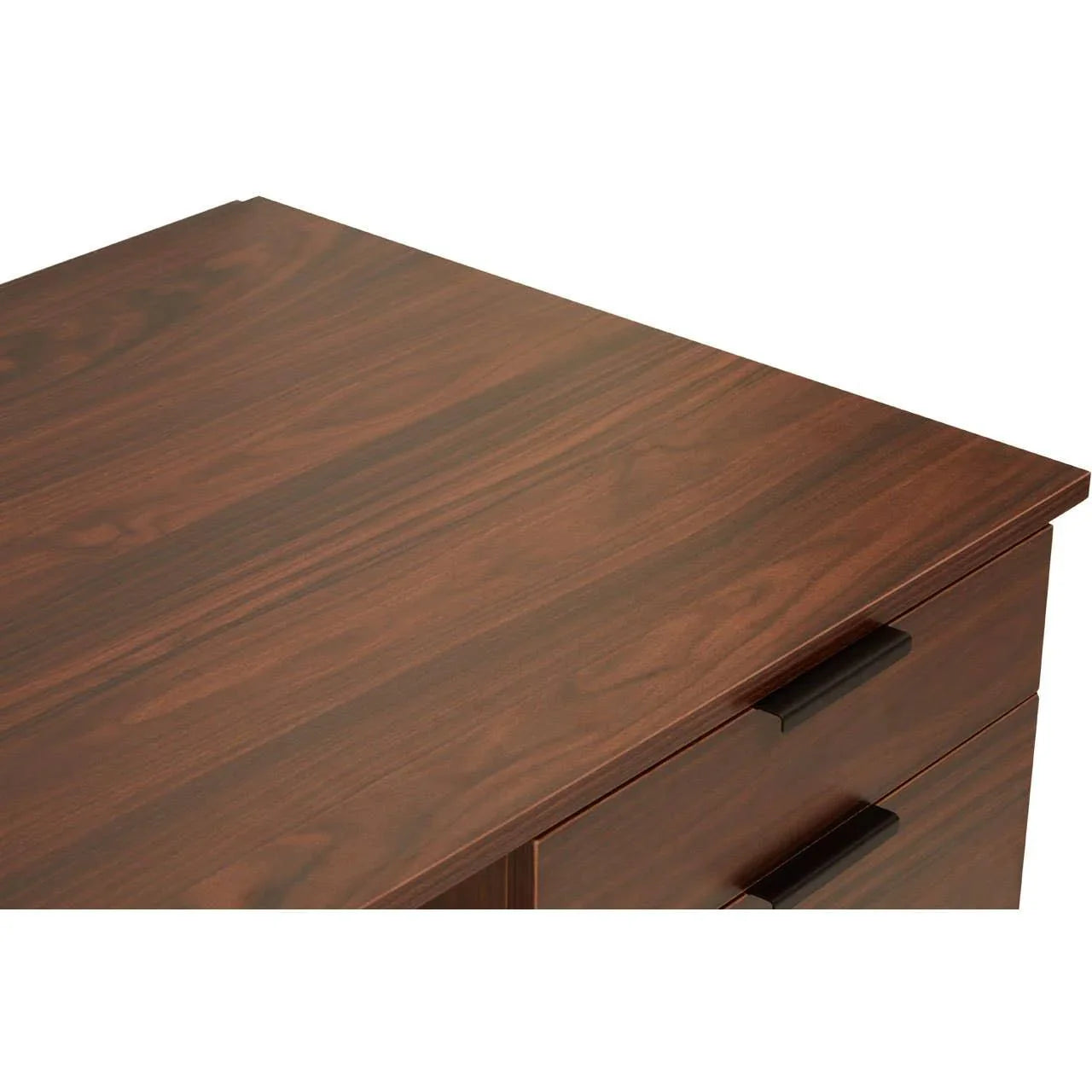 Walnut finish desk with two black drawer handles, closeup of tabletop and corner