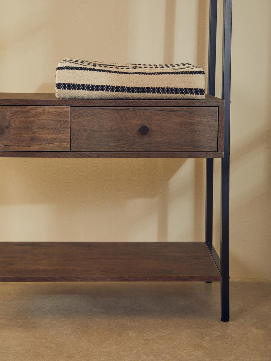 Wood console table with black metal frame, storage drawer and folded striped throw on top