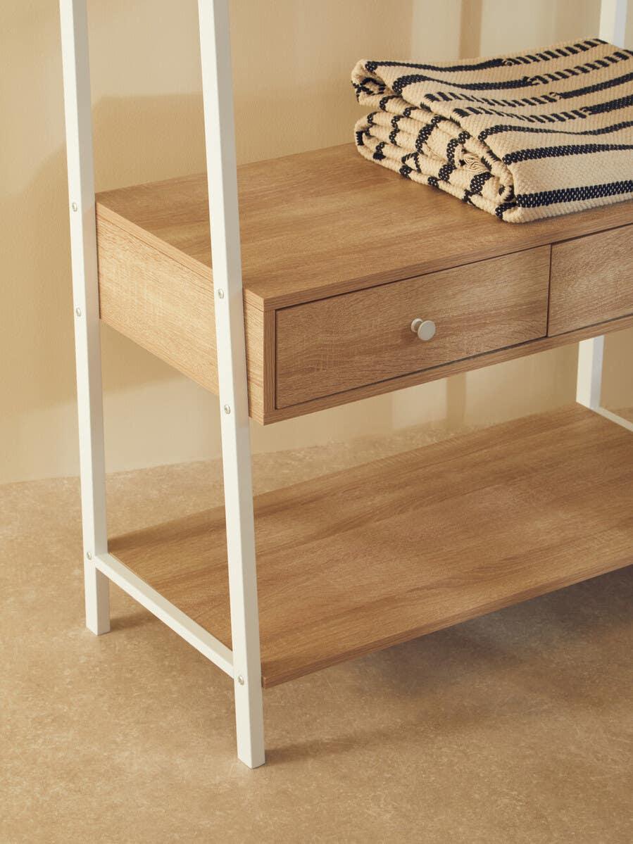 Oak effect shelving unit with white metal frame and two drawers, folded striped throws on shelf