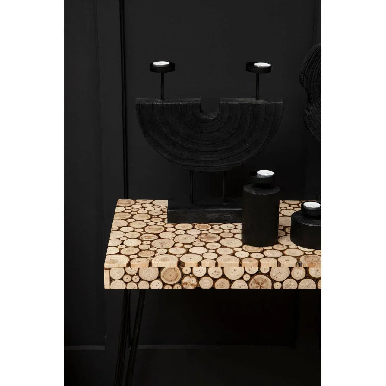 Contemporary console table with round wood slice top and modern black decor accents