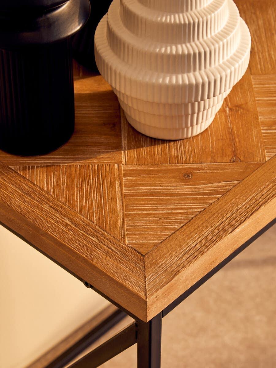 Close-up of wood dining table with black and white ceramic decor on top