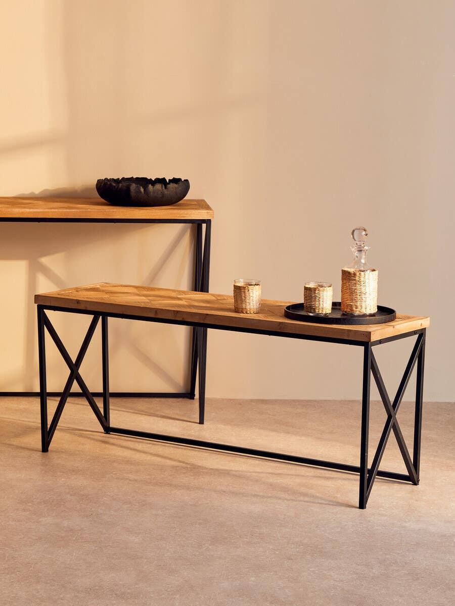 Industrial style wooden console table with black metal frame and decorative accessories