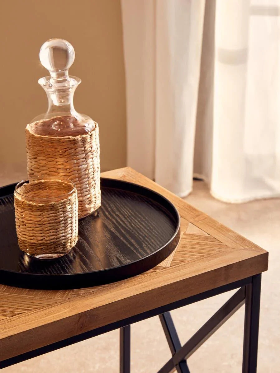 Wooden side table with black tray, wicker glass decanter and matching tumbler