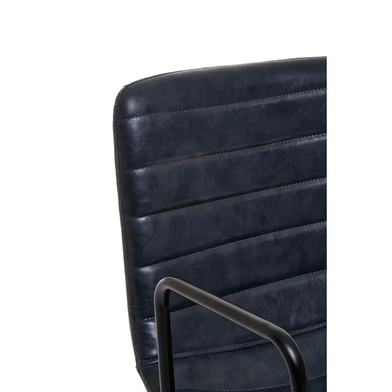 Close up of black faux leather dining chair with horizontal stitching and metal armrest