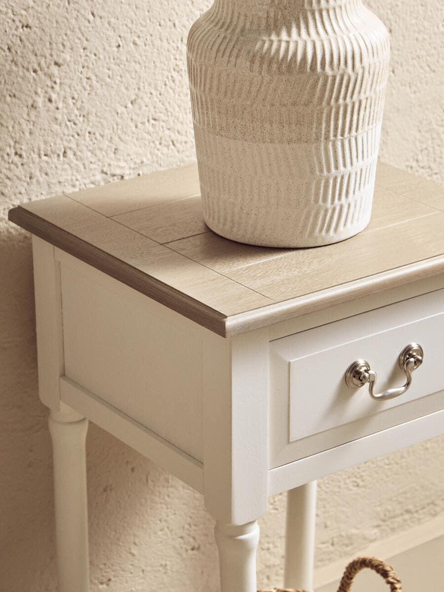 Wooden bedside table with single drawer and light oak top, ceramic vase placed on surface