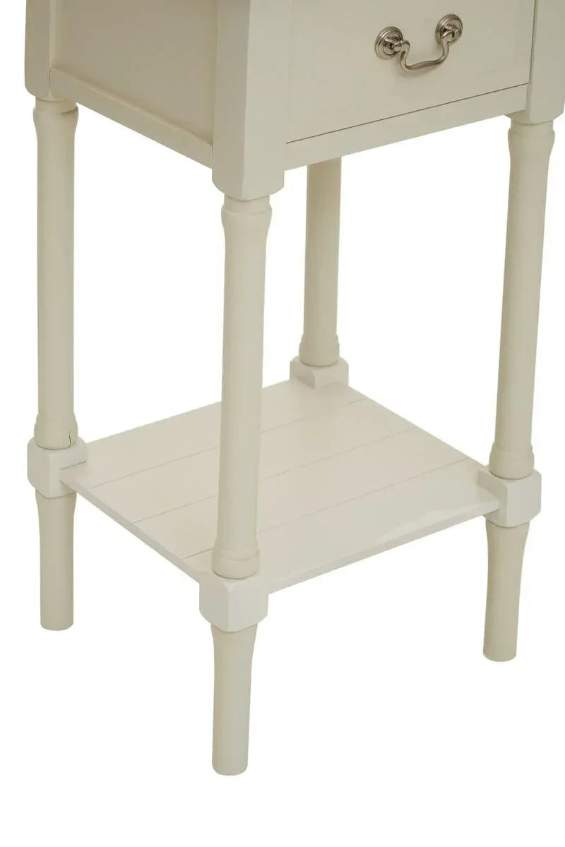 Cream wood side table with lower shelf and turned legs, partial drawer handle visible