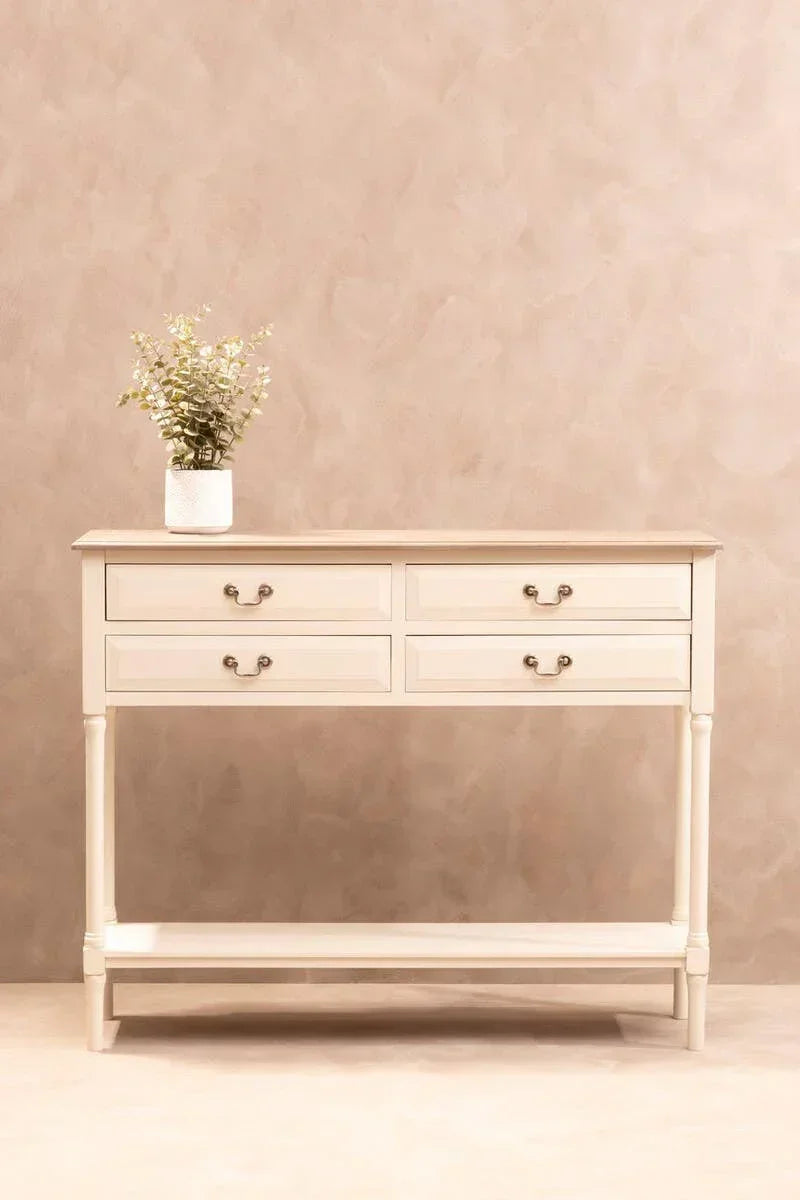 Cream console table with four drawers, lower shelf, and potted plant on top