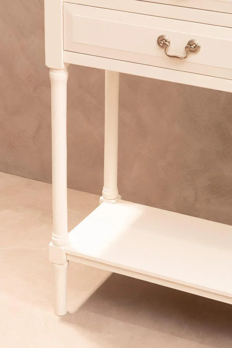 Cream wooden console table with turned legs, lower shelf, and brushed metal drawer handle
