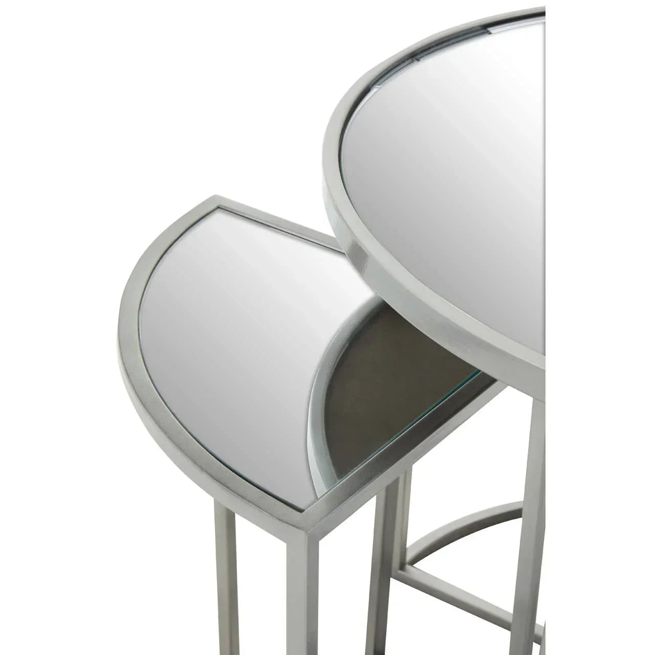 Pair of round mirrored nesting tables with silver metal frames, close-up angle