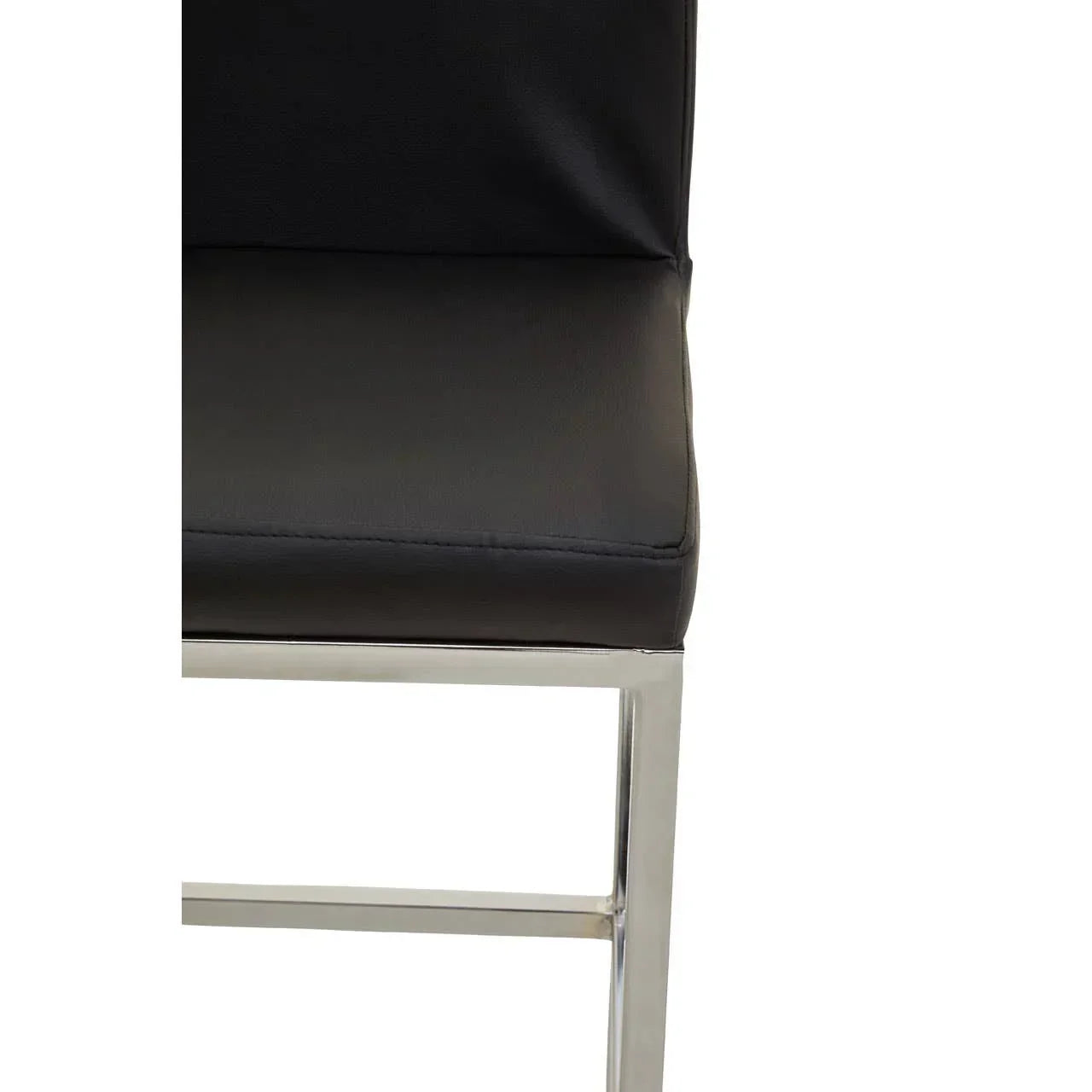 Close view of black dining chair with chrome legs and cushioned seat