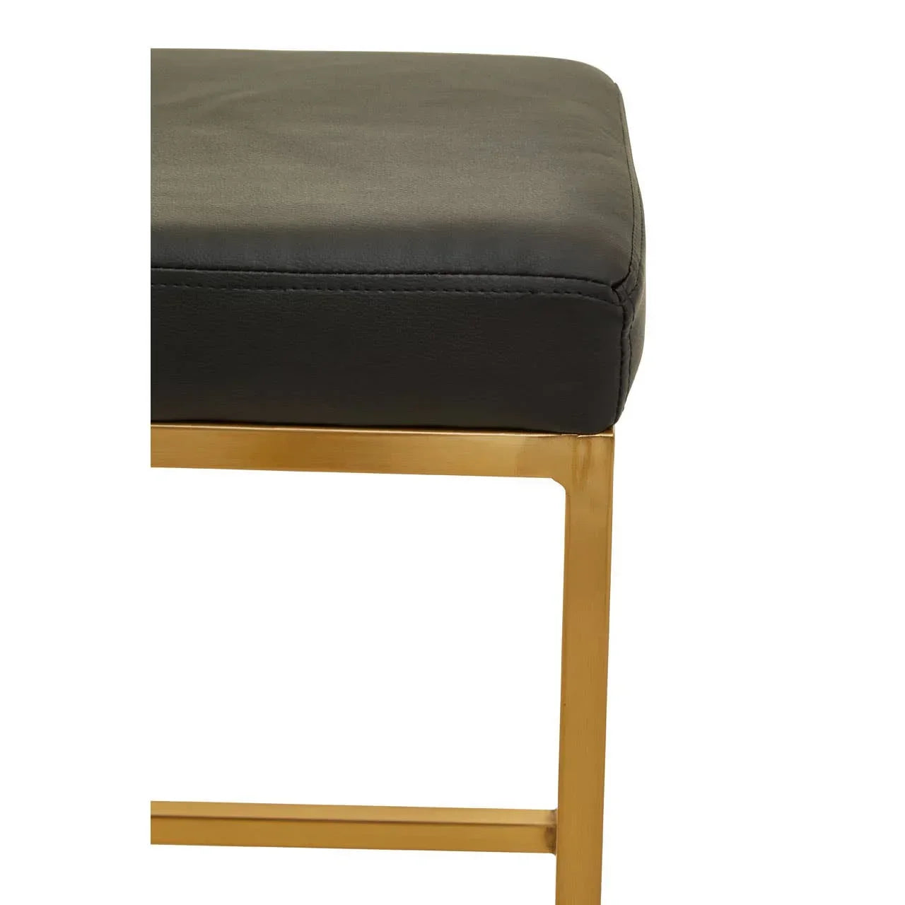 Black leather stool seat with gold metal frame corner detail closeup
