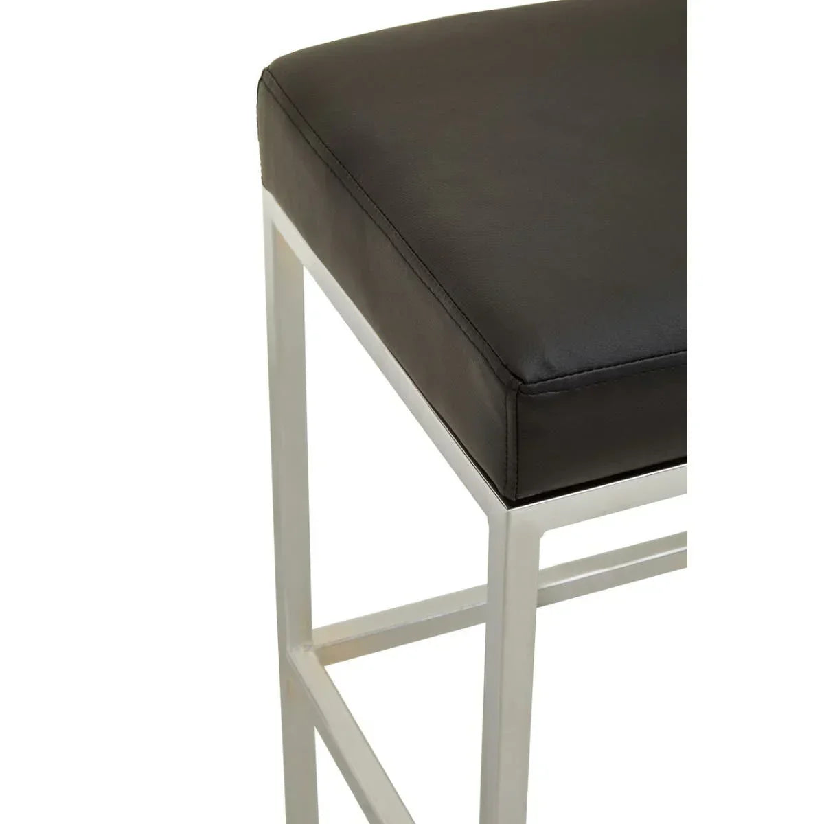 Closeup of black faux leather bar stool seat with chrome metal legs