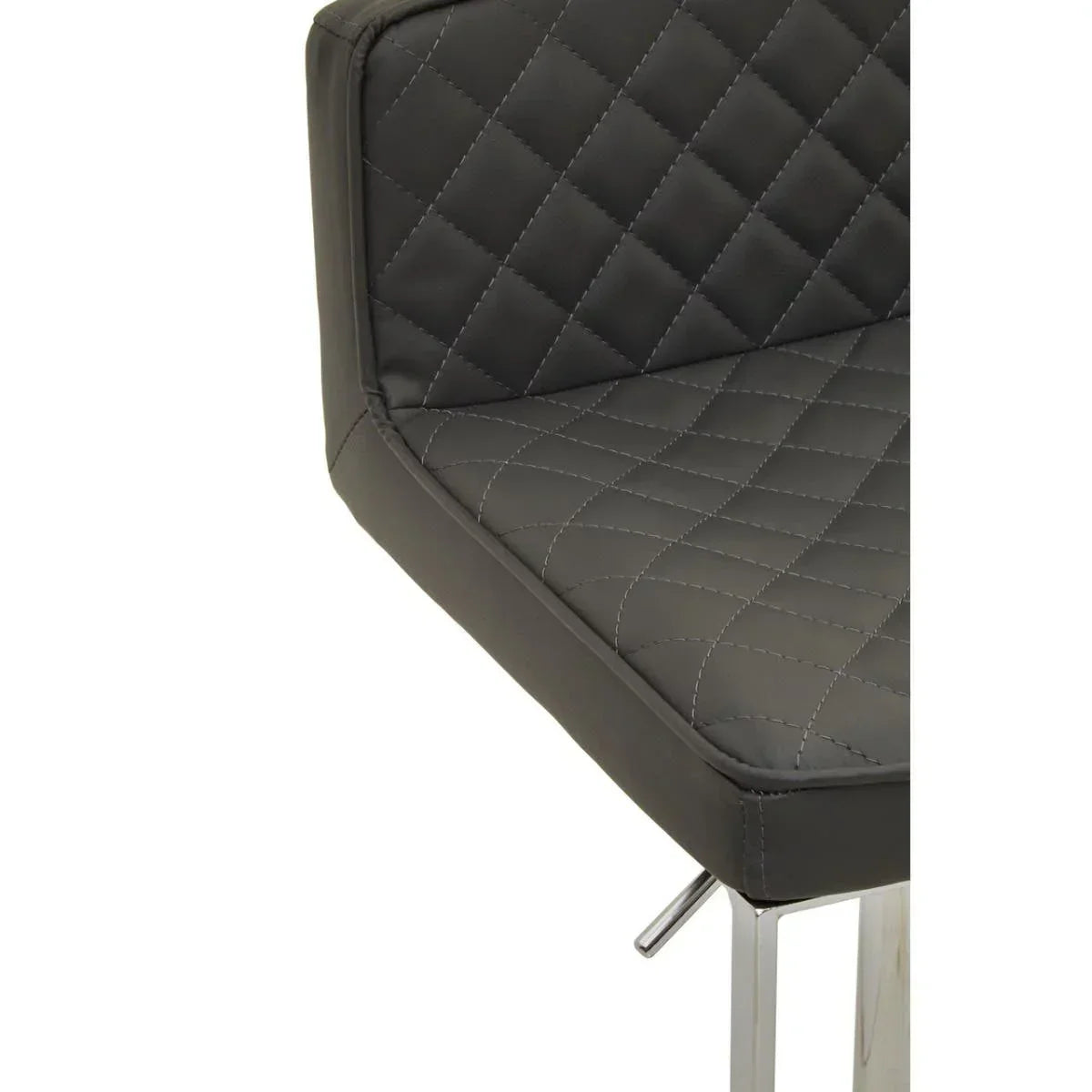 Close up of quilted grey dining chair with chrome legs and stitched detailing