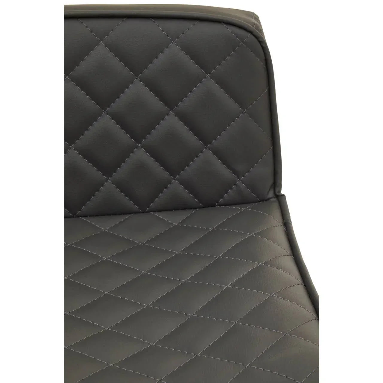 Closeup of black faux leather dining chair with diamond quilted stitching