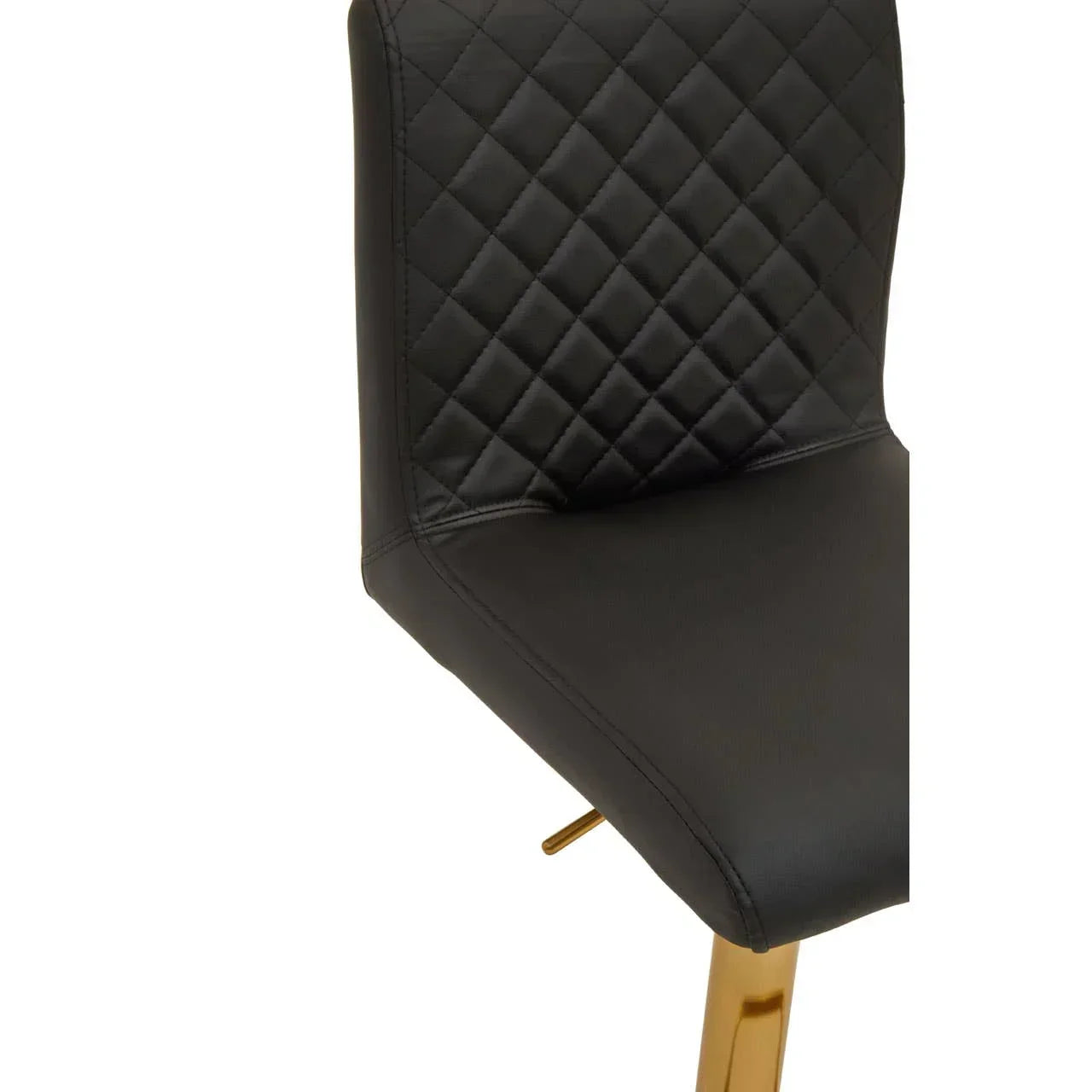 Black dining chair with quilted backrest and gold metal legs, close-up view