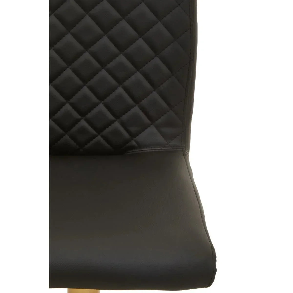Close view of black dining chair with quilted backrest and smooth seat detail