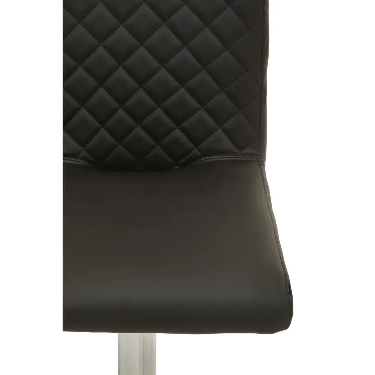 Close-up of black dining chair with quilted backrest and smooth faux leather seat
