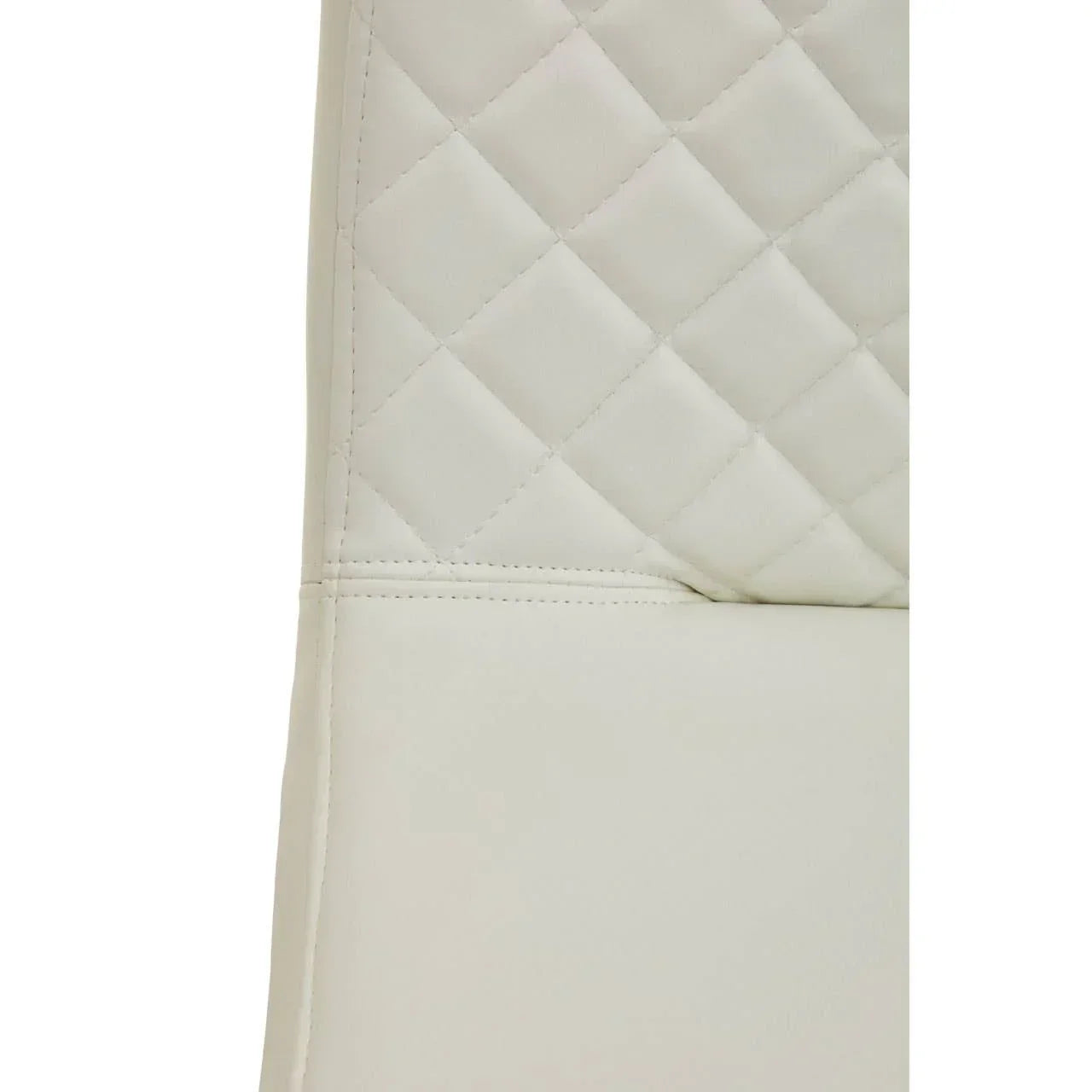Closeup of cream faux leather dining chair with quilted backrest stitching detail