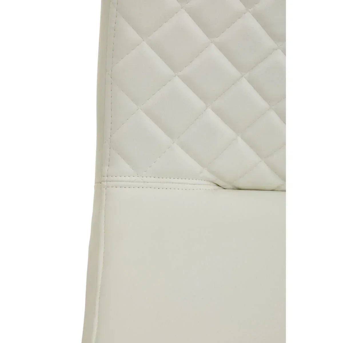 Close view of cream dining chair with diamond quilted faux leather backrest