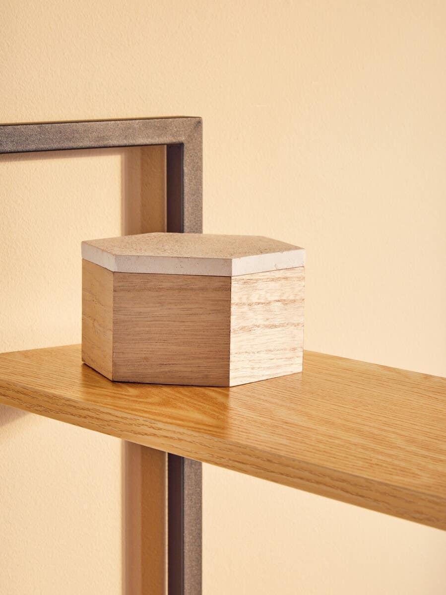 Hexagonal wooden storage box on light oak shelf with metal frame