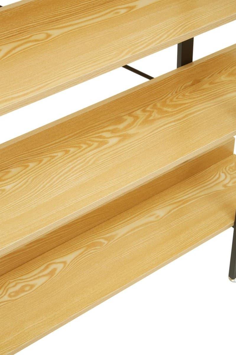 Close view of light wood grain shelving unit with metal supports