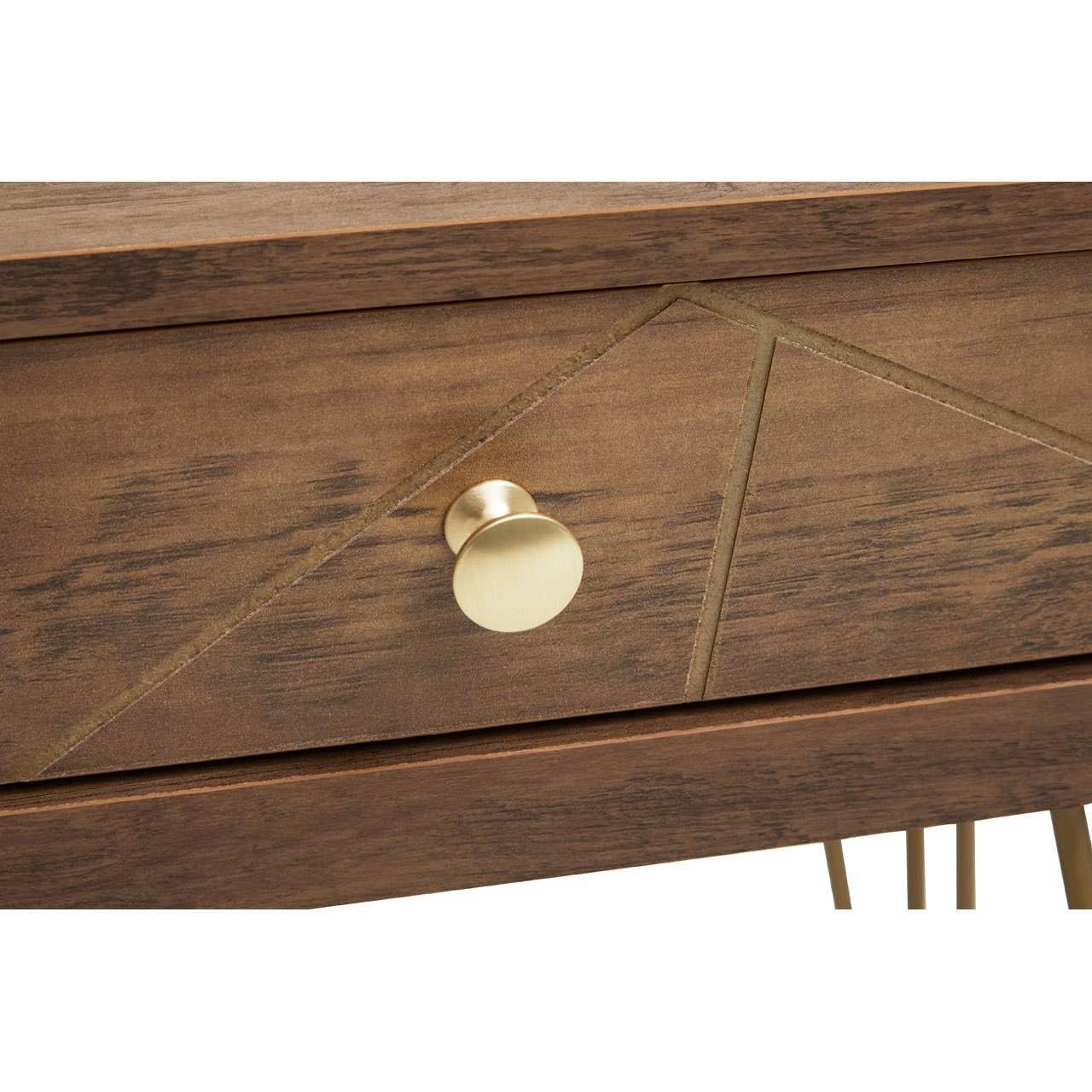 Wooden drawer with gold handle and geometric carved design, close-up of furniture detail