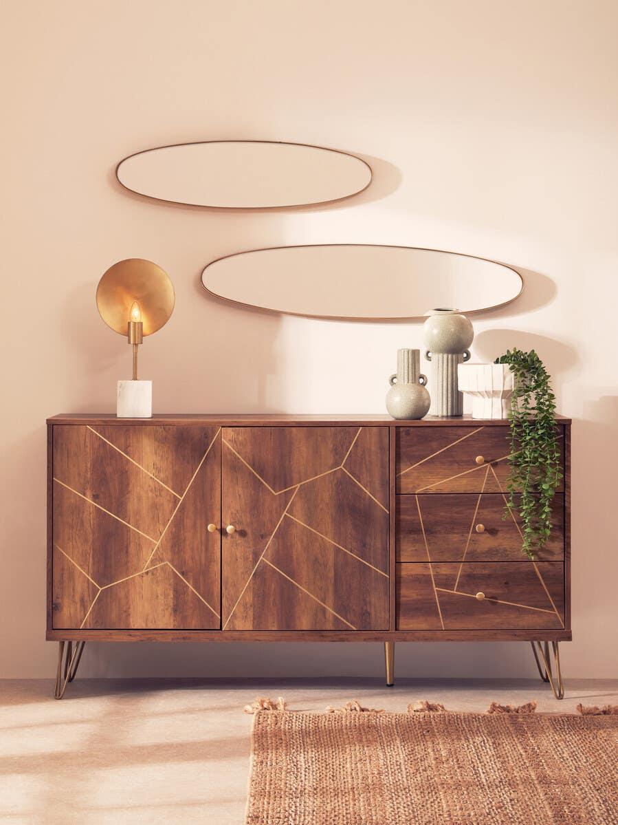 Wood sideboard with gold geometric pattern, metal legs, decor accessories and oval mirrors