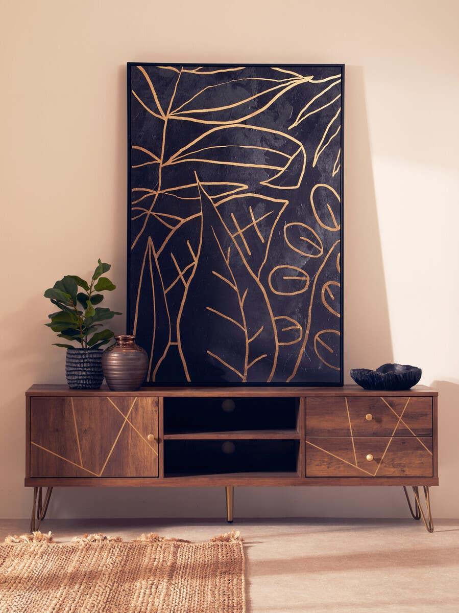 Walnut TV unit with gold details, decorative vases, and abstract leaf wall art