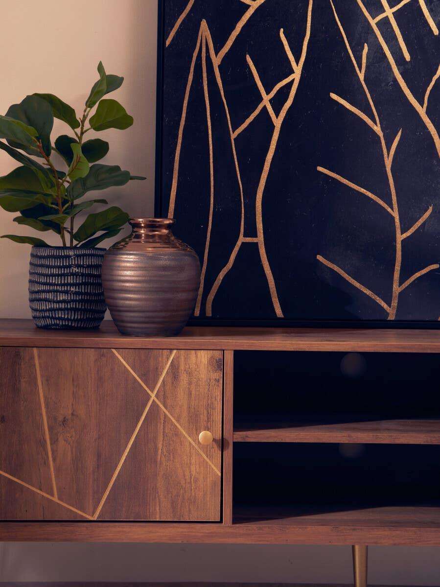 Wooden sideboard with gold geometric detail, ceramic vases, and abstract wall art