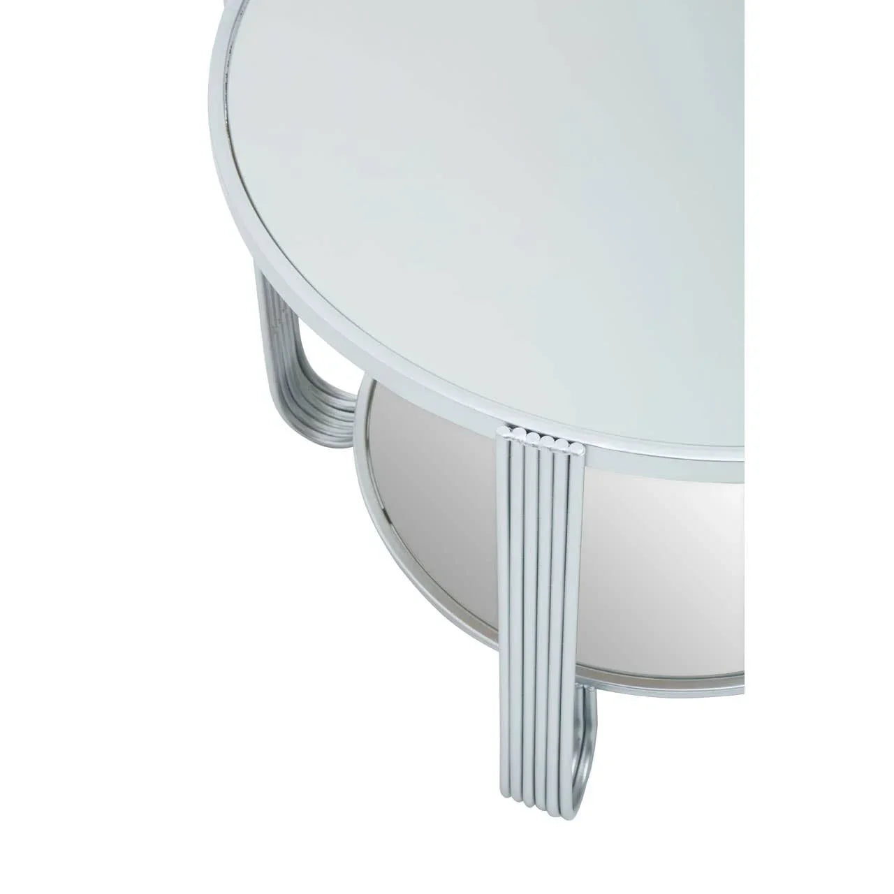 Round mirrored coffee table with metal legs and glass top, close-up angle