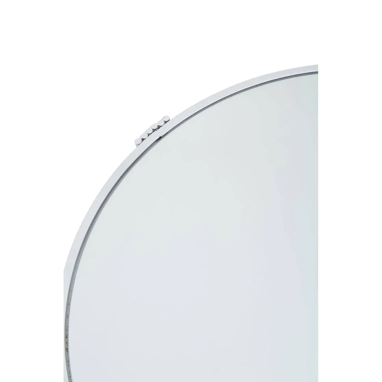 Edge detail of round wall mirror with slim chrome frame and decorative knob accent