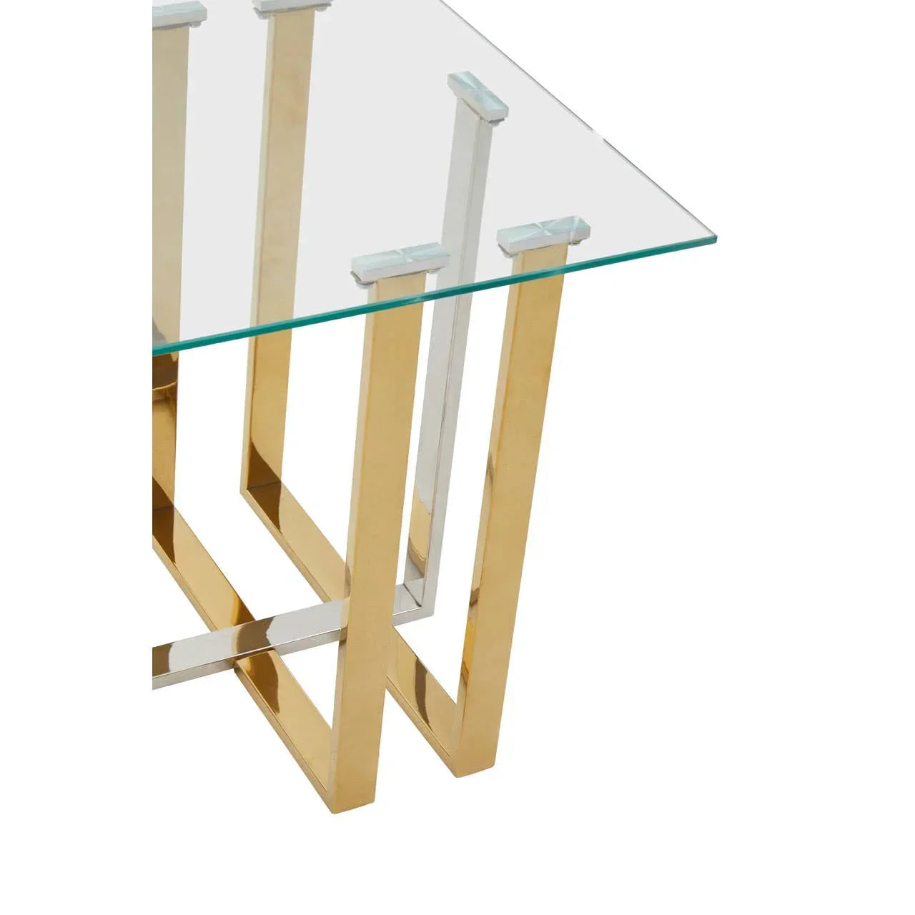 Glass top table with gold and chrome metal legs, modern dining furniture close-up