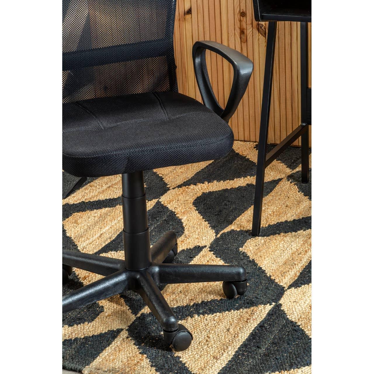 Black mesh office chair with wheels and armrest on geometric rug