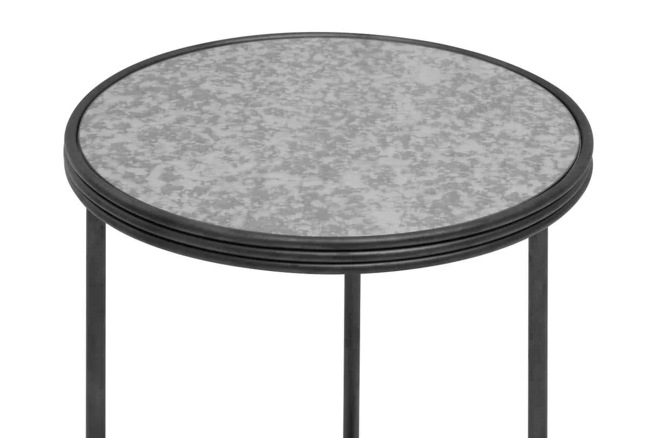 Round metal side table with speckled glass top and slim black legs