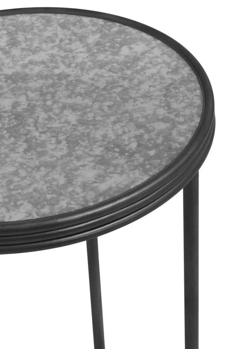 Round glass top side table with black metal frame and slim black legs