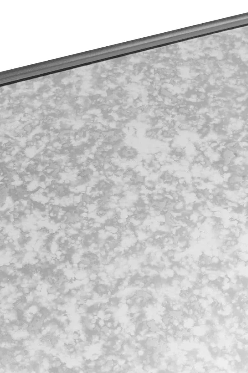 Close up of antique mirrored glass furniture surface with grey metallic border