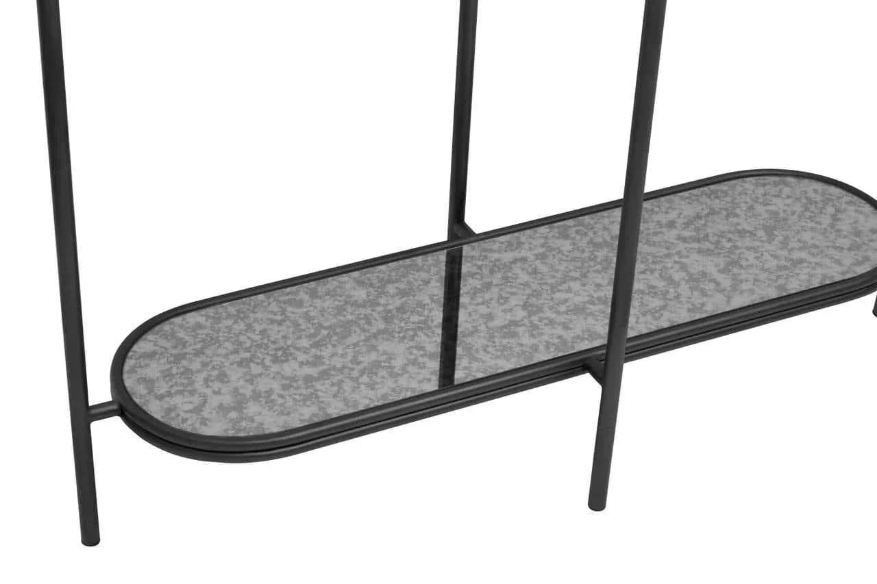 Close-up of metal and glass shelf with oval base and black frame