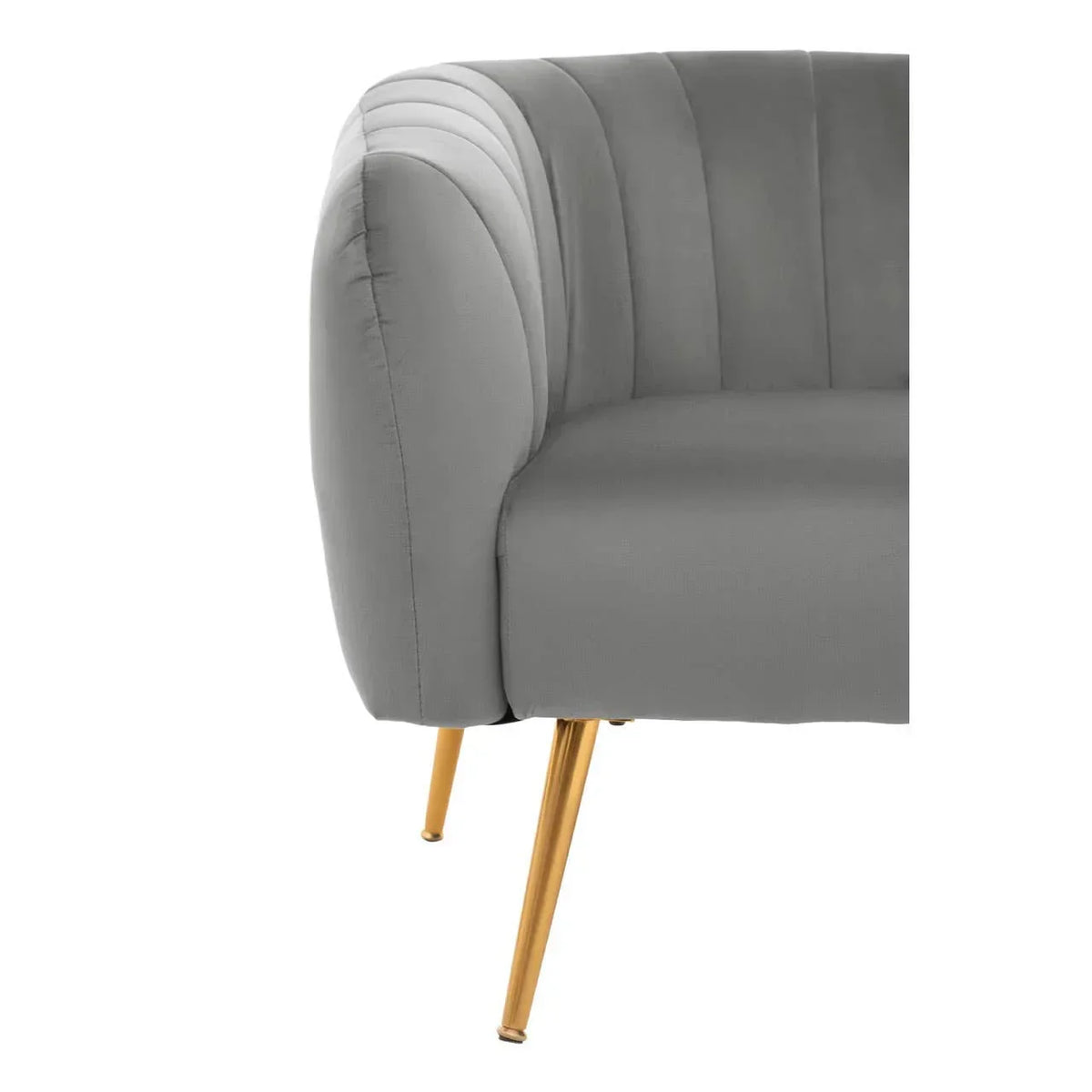 Grey velvet sofa with channel tufted backrest and gold metal legs, closeup side view