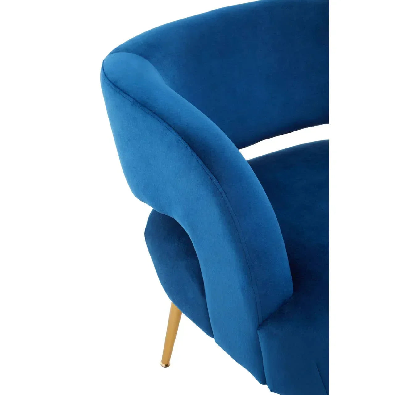 Blue velvet accent chair with curved backrest and gold metal legs, close-up side view
