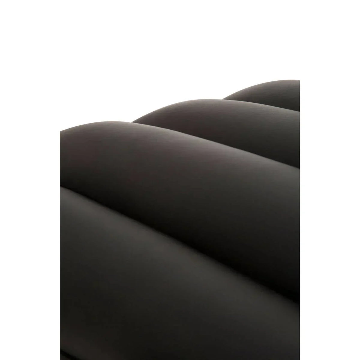Close view of dark upholstered sofa backrest with horizontal stitched panels