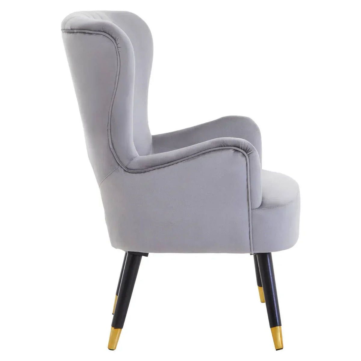 Grey velvet accent chair with curved backrest and gold-tipped black legs, side view