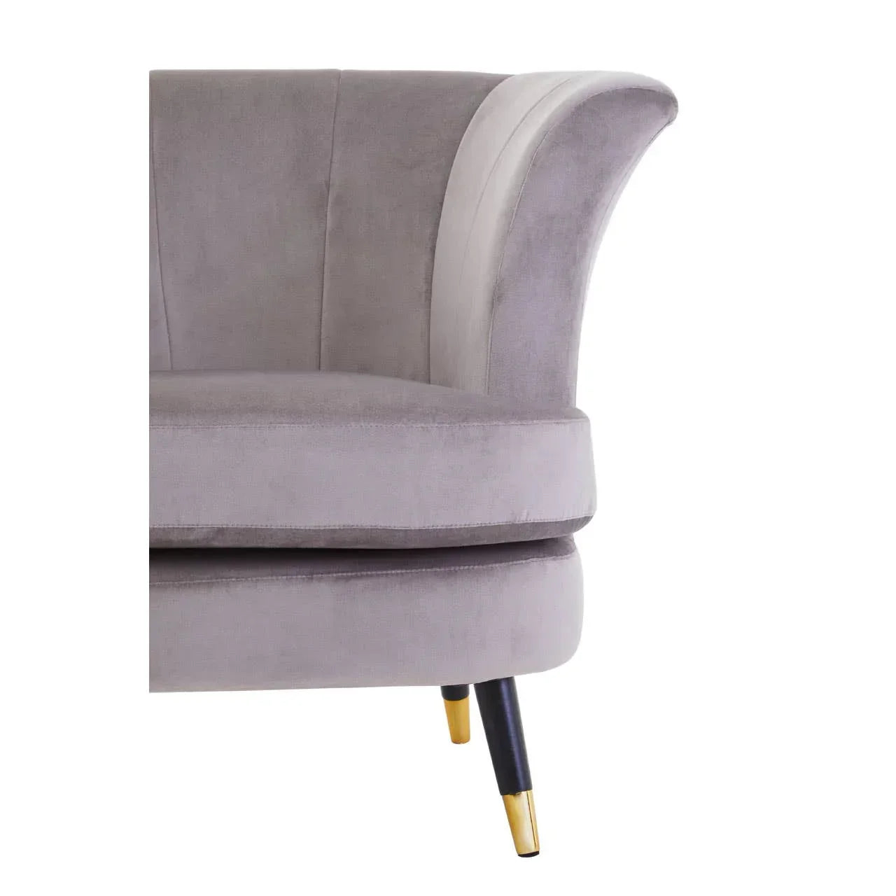 Grey velvet sofa with flared armrest and gold-tipped black leg, close-up view