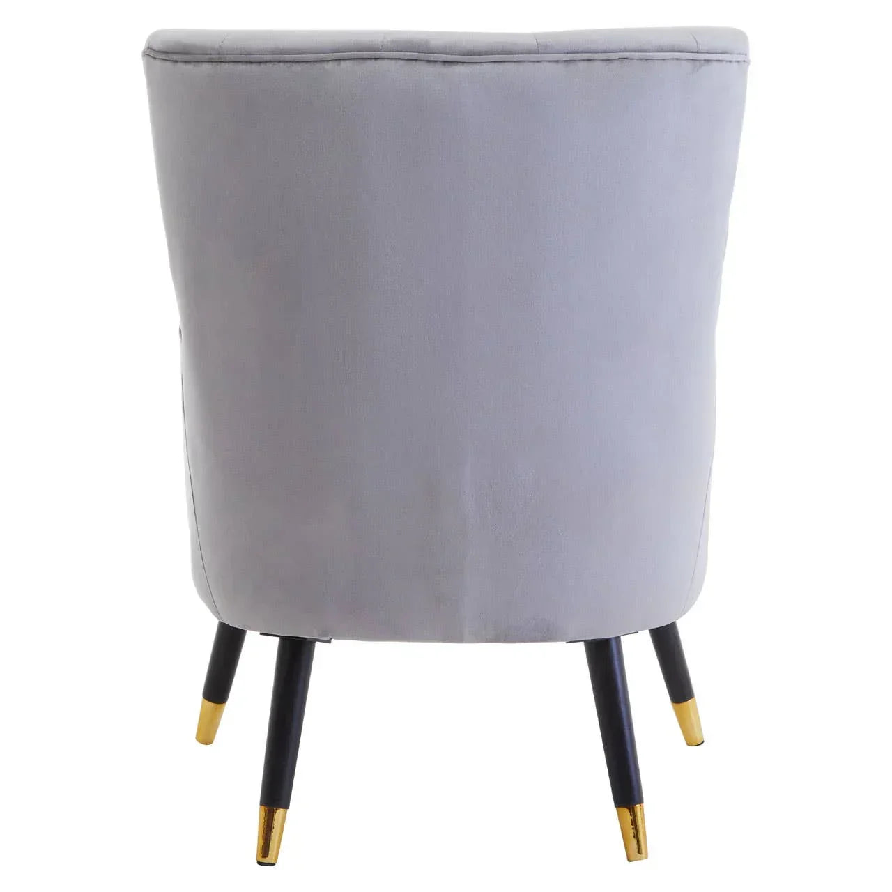 Back view of grey velvet accent chair with black legs and gold tips