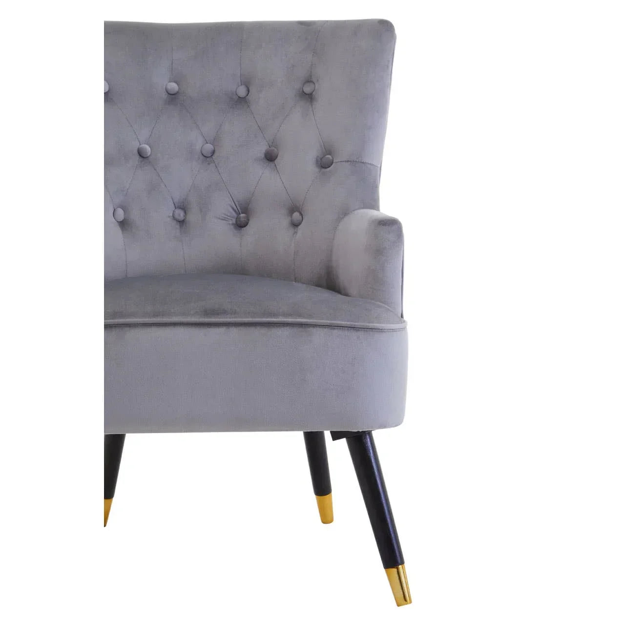Grey velvet accent chair with button-tufted back and gold-tipped black wooden legs