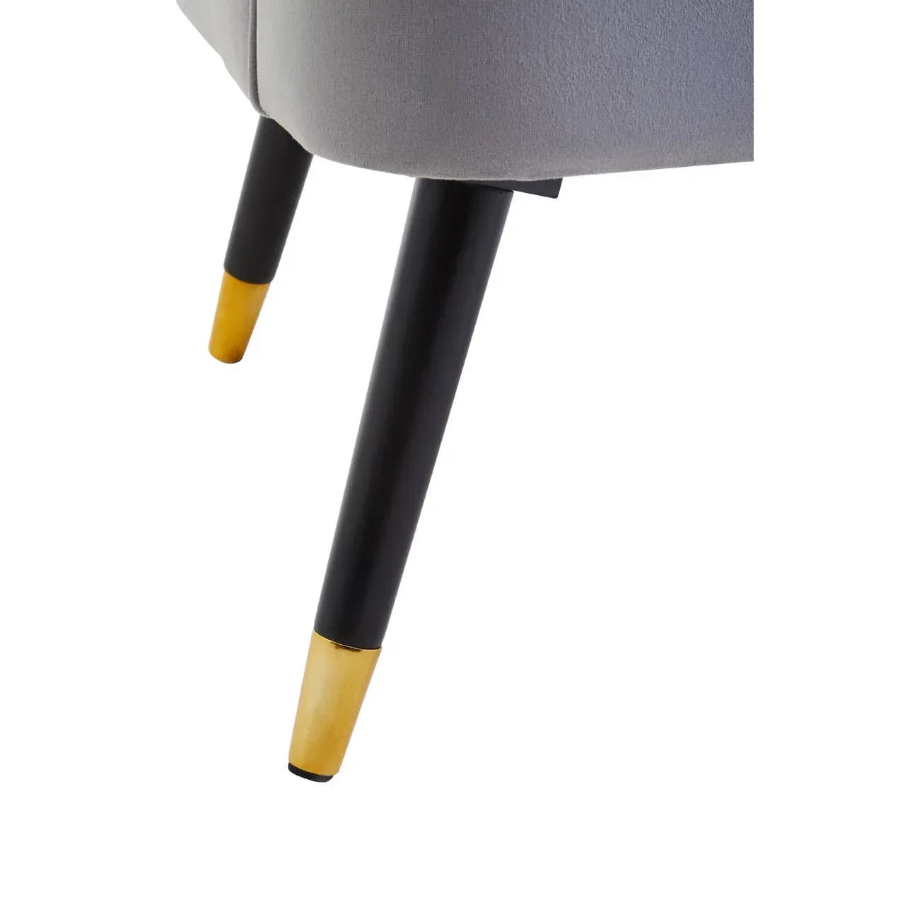 Black and gold sofa leg detail on grey upholstered furniture