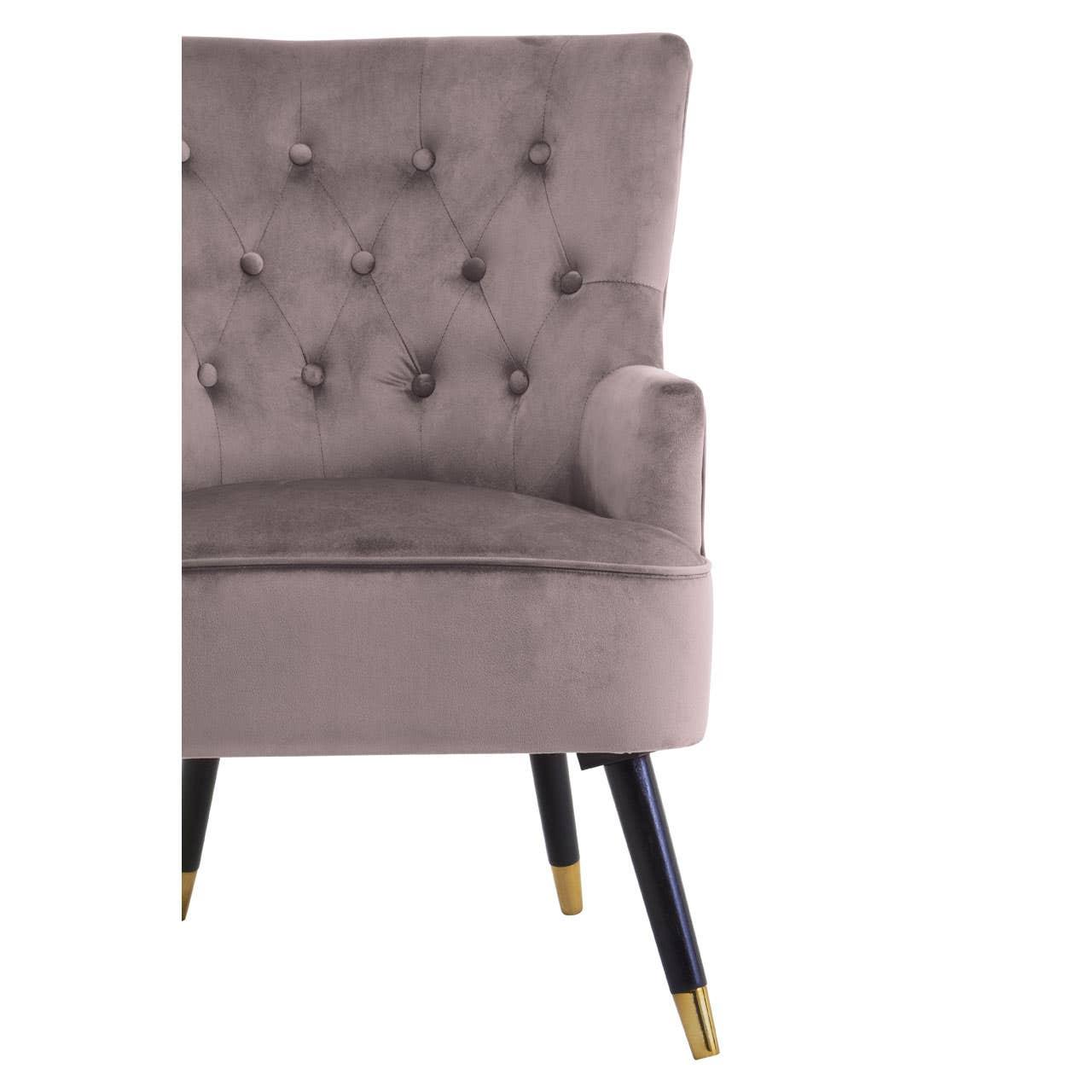 Taupe velvet accent chair with button backrest and tapered black legs with gold tips