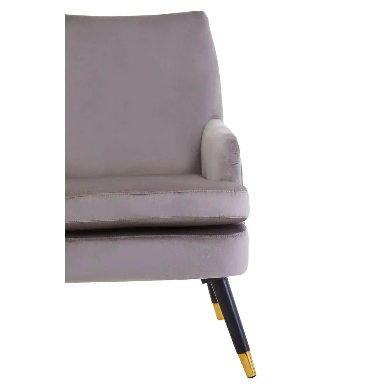 Grey velvet armchair with angled black legs and gold dipped feet, close side view